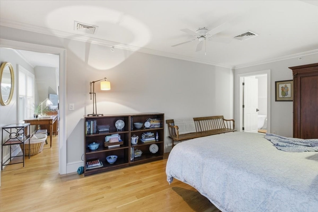 1090 Shore Road, Unit 7 Bourne, MA 02559 - Photo 26 of 42 a bedroom with a bed a mirror and furniture