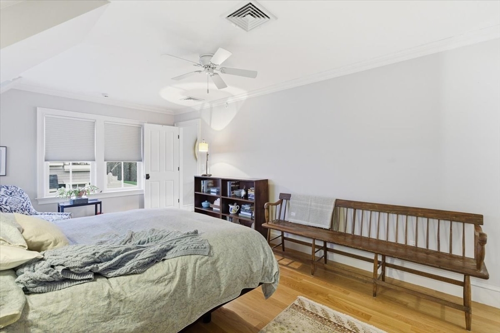1090 Shore Road, Unit 7 Bourne, MA 02559 - Photo 28 of 42 a spacious bedroom with a bed a couch and window