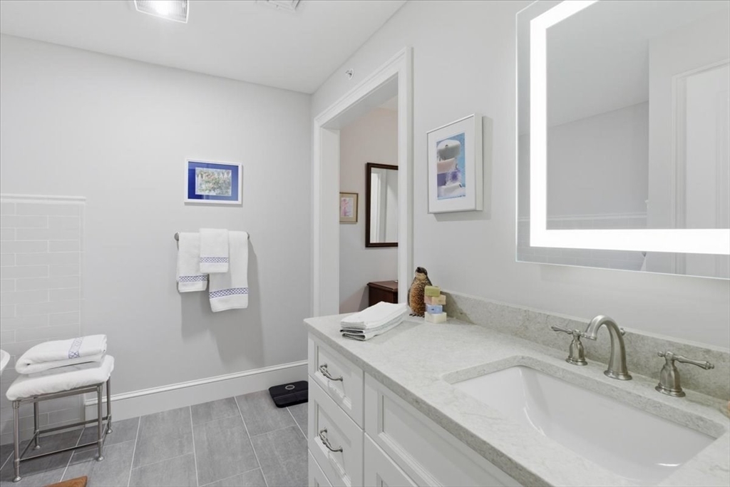 1090 Shore Road, Unit 7 Bourne, MA 02559 - Photo 30 of 42 a bathroom with a sink and a mirror