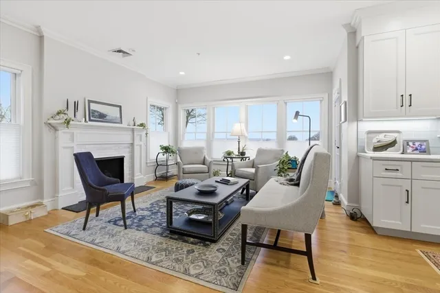 a living room with furniture a rug and a fireplace