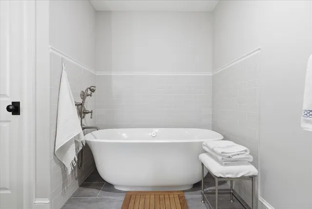 a white bath tub sitting next to a white toilet and sink