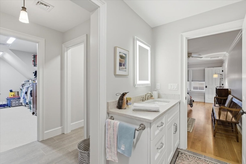 1090 Shore Road, Unit 7 Bourne, MA 02559 - Photo 32 of 42 a bathroom with a sink a mirror and a shower