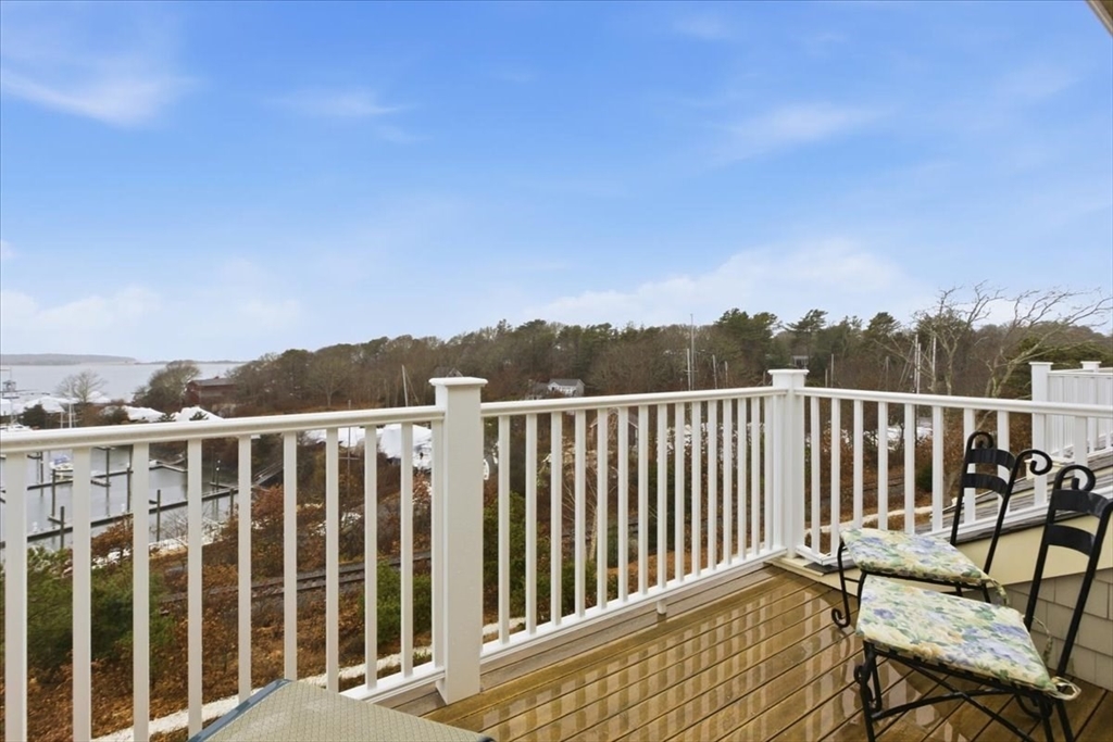 1090 Shore Road, Unit 7 Bourne, MA 02559 - Photo 37 of 42 a view of a chair and table on the terrace