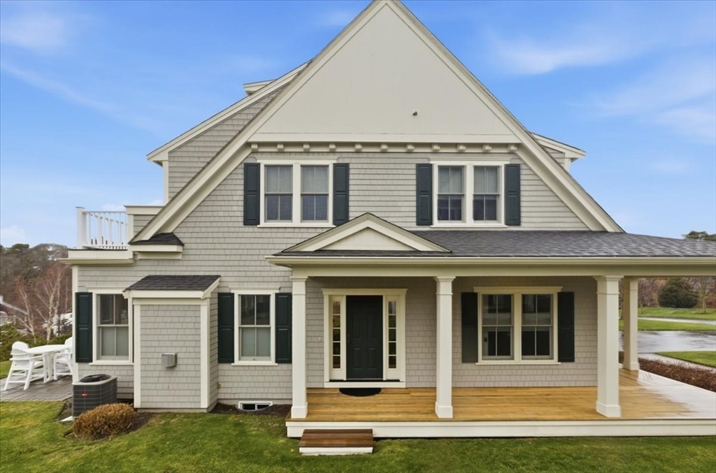 1090 Shore Road, Unit 7 Bourne, MA 02559 - Photo 40 of 42 a front view of a house with a yard