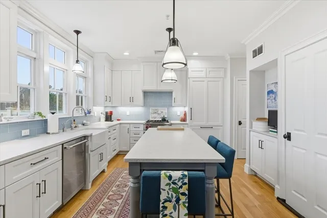 a kitchen with a sink appliances and cabinets