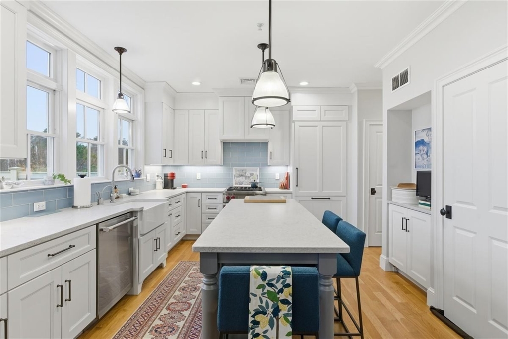 1090 Shore Road, Unit 7 Bourne, MA 02559 - Photo 6 of 42 a kitchen with a sink appliances and cabinets