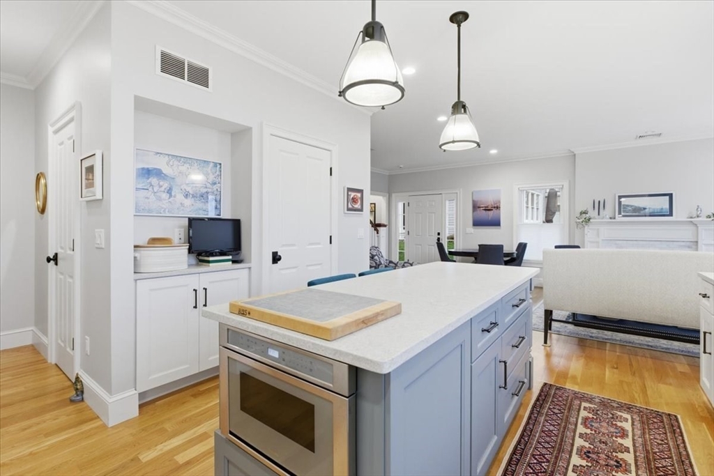 1090 Shore Road, Unit 7 Bourne, MA 02559 - Photo 9 of 42 a view of a kitchen and a sink dishwasher and wooden floor