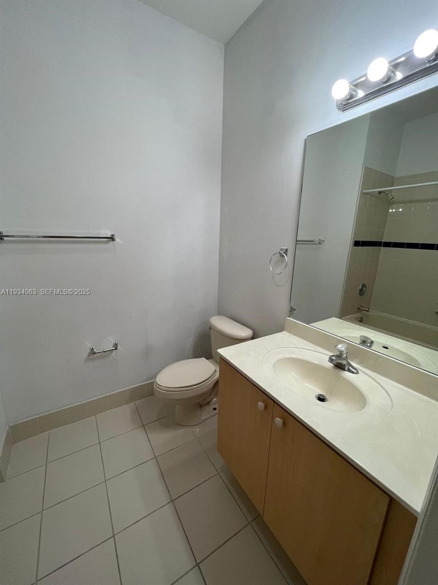 11024 Southwest 237th Lane Homestead, FL 33032 - Photo 4 of 16 a bathroom with a sink a toilet and mirror