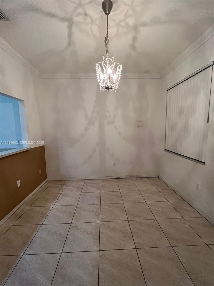 11024 Southwest 237th Lane Homestead, FL 33032 - Photo 6 of 16 a view of a kitchen with a sink and a chandelier