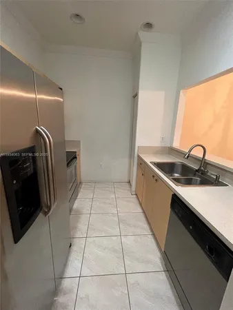 a kitchen with a sink and a stove top oven