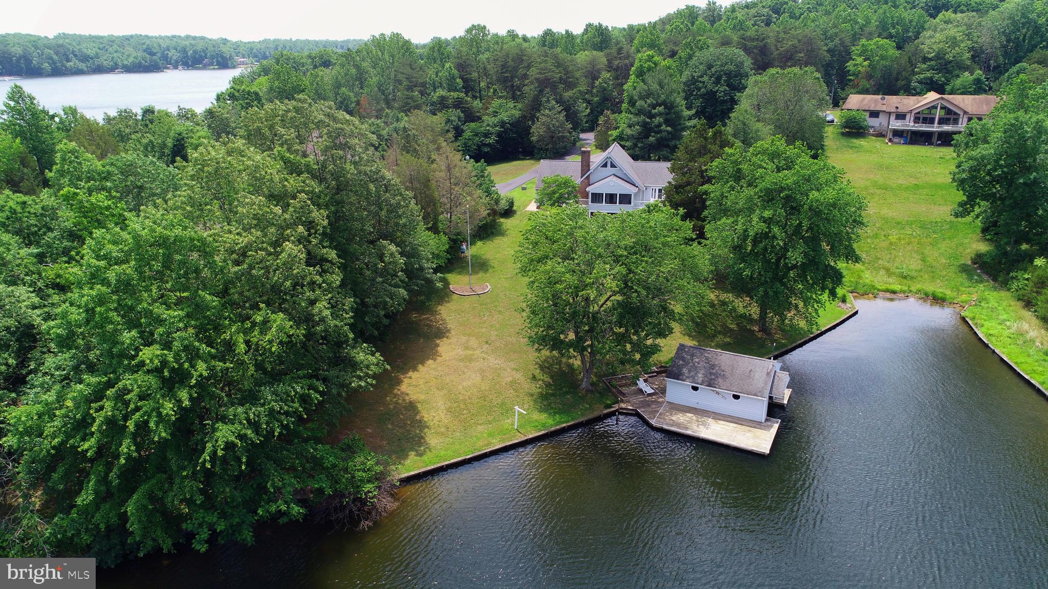 737 Plum Tree Road Bumpass, VA 23024 - Photo 26 of 46 Bulkhead waterfront with covered boathouse