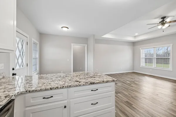 a bathroom with a granite countertop sink and mirror