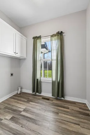 a view of a livingroom with wooden floor and a window