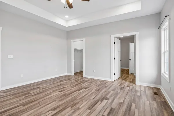 a view of hallway with wooden floor