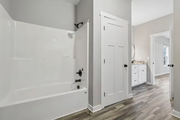 a bathroom with a bathtub and a shower