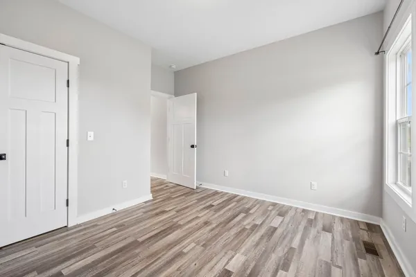 a view of an empty room and wooden floor