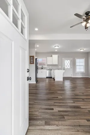 a view of a kitchen with kitchen island a sink stainless steel appliances and cabinets