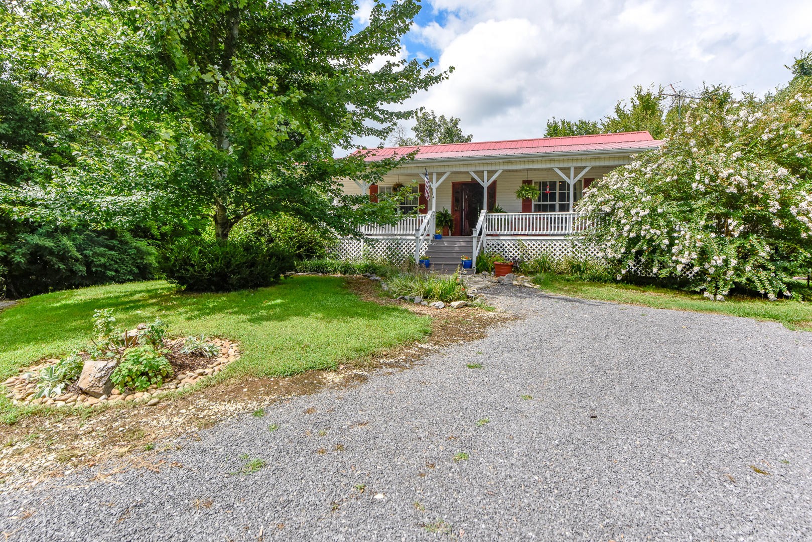 297 Lester Whitt Road Rutledge, TN 37861 - Photo 1 of 27 a front view of a house with garden