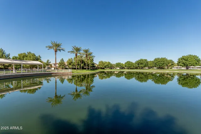 a view of a patio with a table and chairs under an umbrella