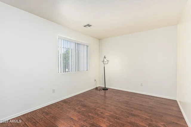 a view of a house with backyard and trees