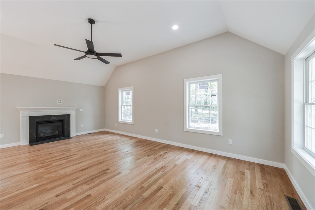 86 New Boston Road Kingston, NH 03848 - Photo 8 of 30 a view of an empty room with wooden floor fireplace and a window