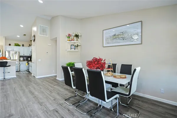 a view of a dining room with furniture and wooden floor