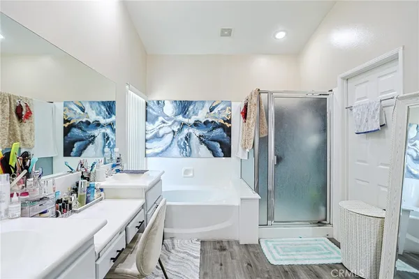 a bathroom with a tub sink and mirror