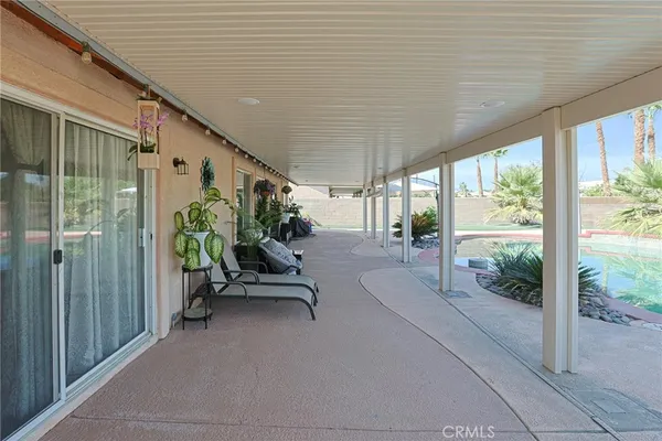 a balcony with furniture and garden view
