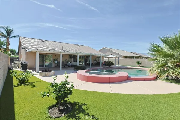 a front view of house with yard and outdoor seating