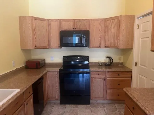 a kitchen with a cabinets and a stove top oven