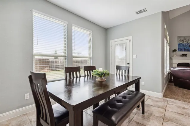 a view of a dining room with furniture and window