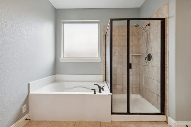 a white bath tub sitting next to a shower