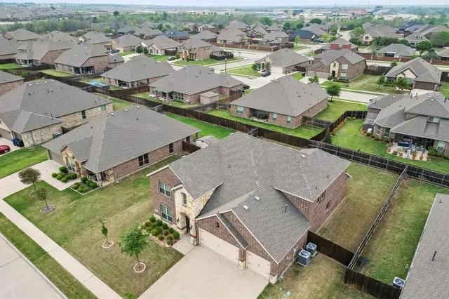 an aerial view of a house with a yard