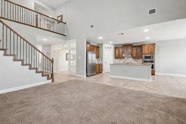 a view of a kitchen with a sink and a refrigerator