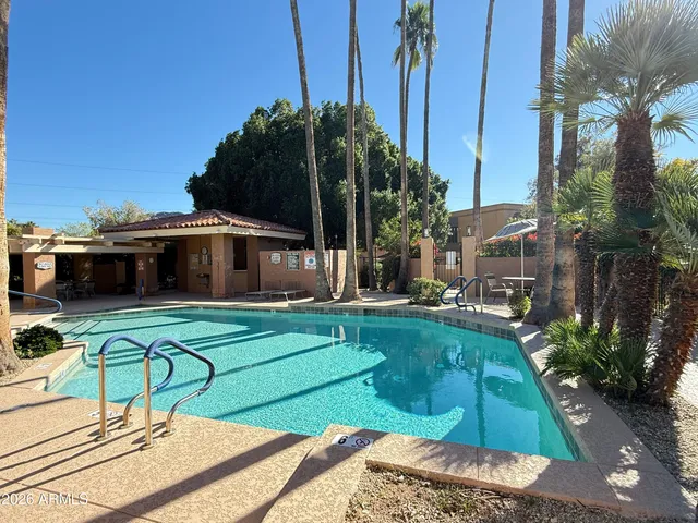 a view of a house with backyard patio and swimming pool