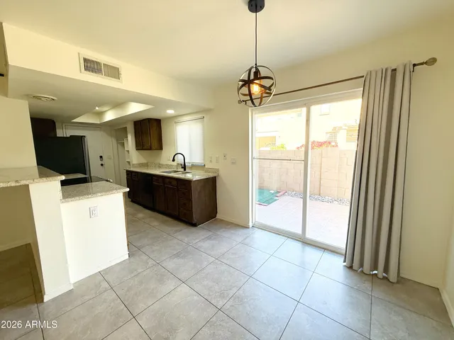 a view of a kitchen with furniture and a ceiling fan