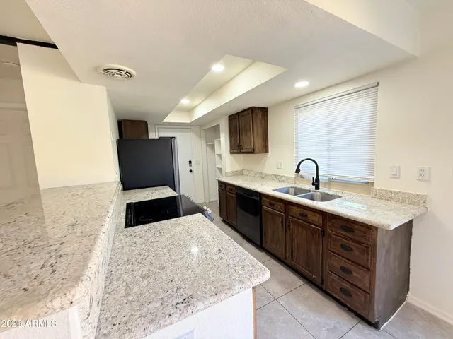 a large kitchen with kitchen island a sink stainless steel appliances and cabinets