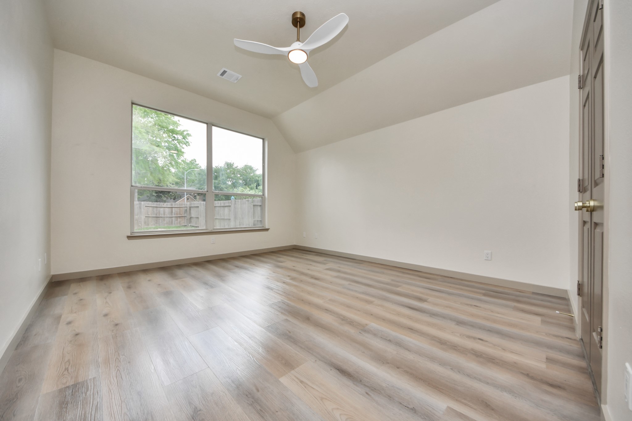 14423 Gadwall Court Houston, TX 77044 - Photo 30 of 42 an empty room with wooden floor chandelier fan and windows