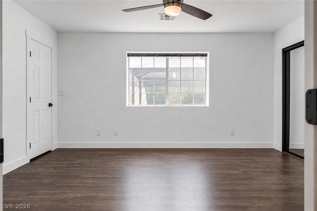 524 Swallow Cove Boulder City, NV 89005 - Photo 18 of 58 Rich hardwood-style flooring and a ceiling fan provide comfort in this versatile room.
