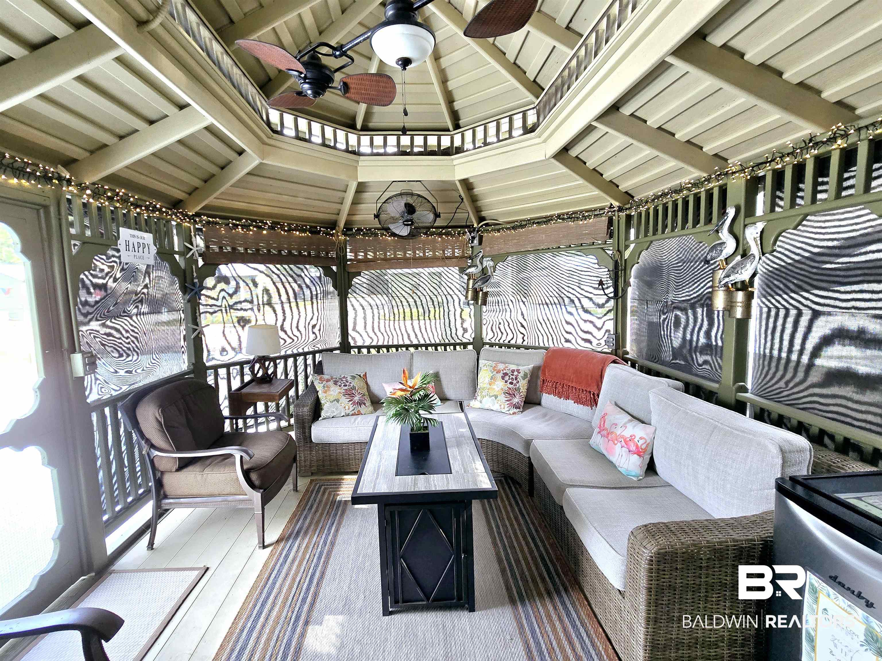 Wooden deck with outdoor lounge area and ceiling fan