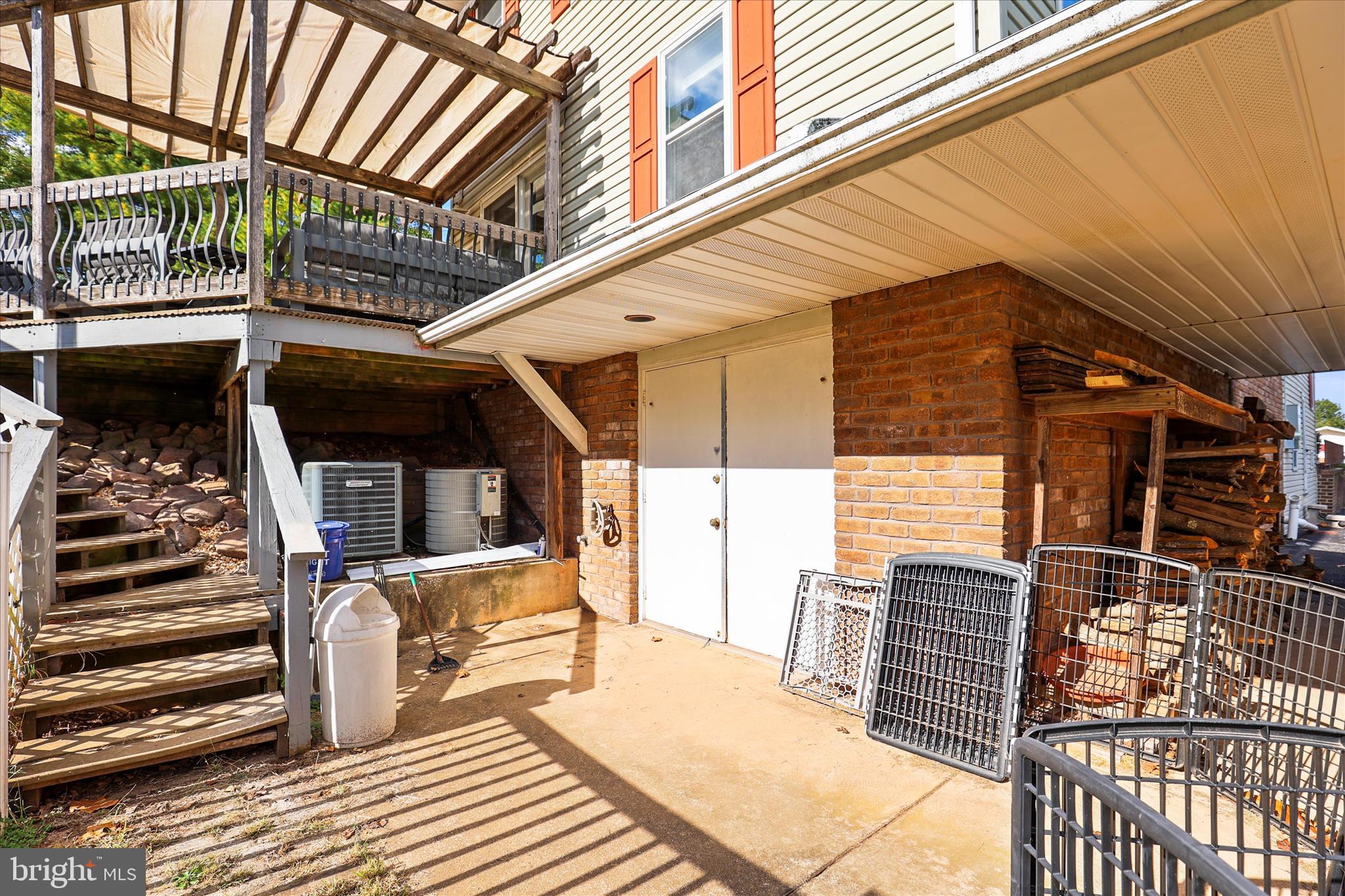 810 Copenhaffer Road York, PA 17404 - Photo 31 of 57 a view of a balcony with two couches and wooden floor with iron stairs