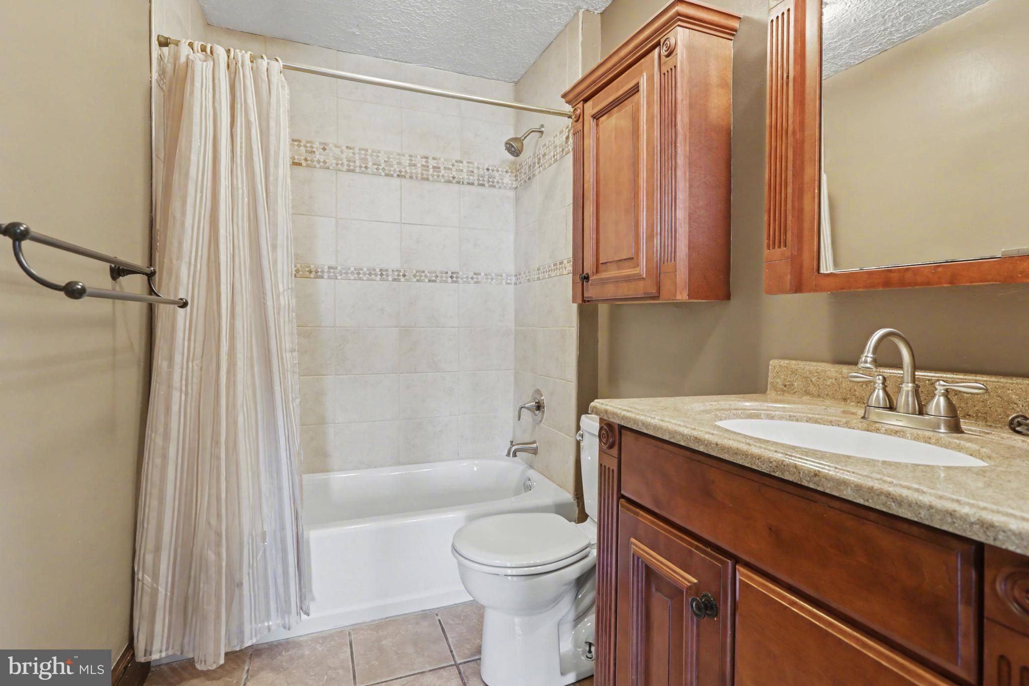 810 Copenhaffer Road York, PA 17404 - Photo 40 of 57 a bathroom with a granite countertop sink toilet and shower