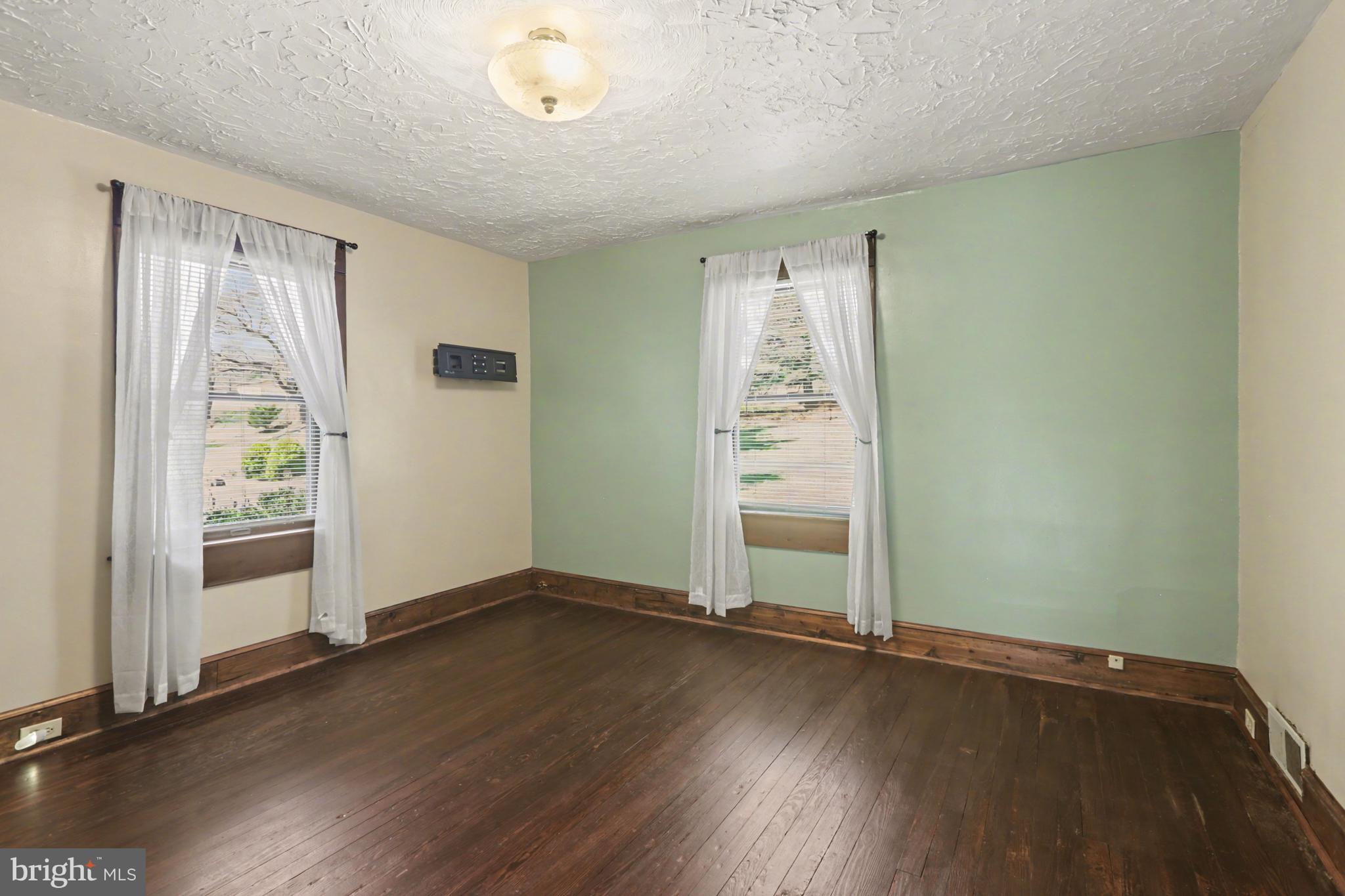 810 Copenhaffer Road York, PA 17404 - Photo 42 of 57 an empty room with wooden floor and windows