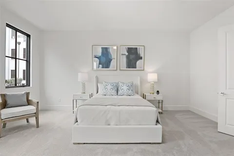 a bedroom with a bed and a couch