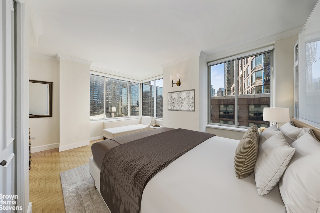 200 Riverside Boulevard, Unit 15I Manhattan, NY 10069 - Photo 10 of 23 a bedroom with a large bed and a large window
