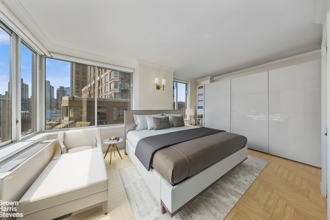 200 Riverside Boulevard, Unit 15I Manhattan, NY 10069 - Photo 12 of 23 a bedroom with a large bed and a large window