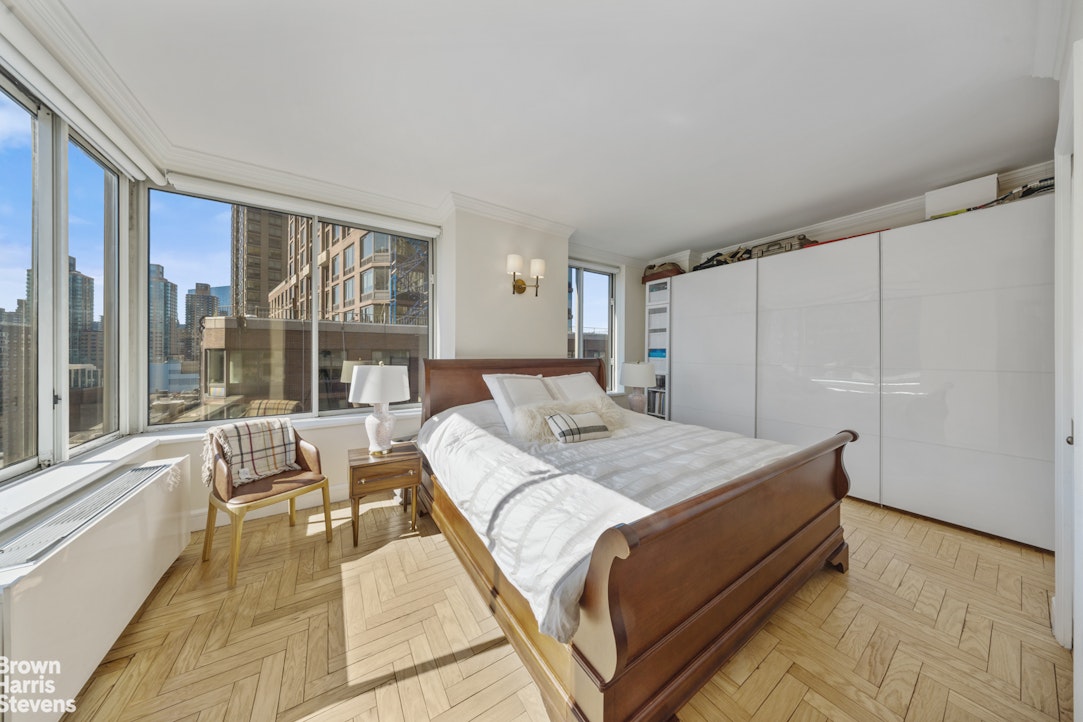 200 Riverside Boulevard, Unit 15I Manhattan, NY 10069 - Photo 13 of 23 a spacious bedroom with a bed and a large window