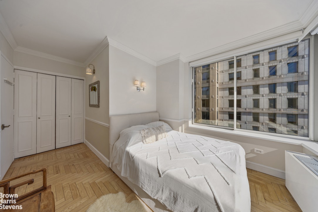 200 Riverside Boulevard, Unit 15I Manhattan, NY 10069 - Photo 17 of 23 a bedroom with a bed and a window