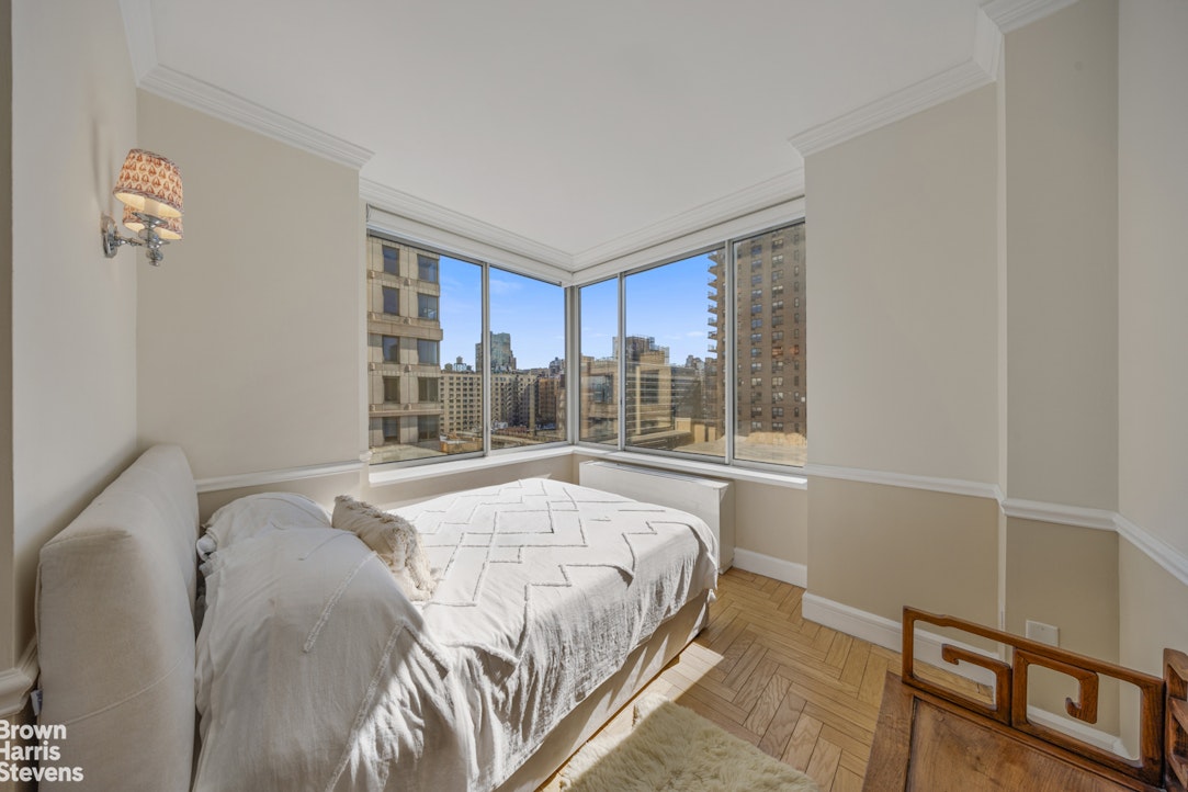 200 Riverside Boulevard, Unit 15I Manhattan, NY 10069 - Photo 18 of 23 a bed sitting in a bedroom next to a window