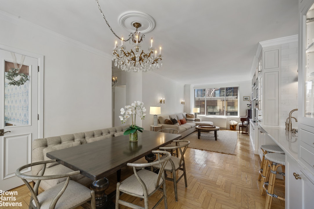 200 Riverside Boulevard, Unit 15I Manhattan, NY 10069 - Photo 6 of 23 a view of a dining room with furniture a chandelier and wooden floor
